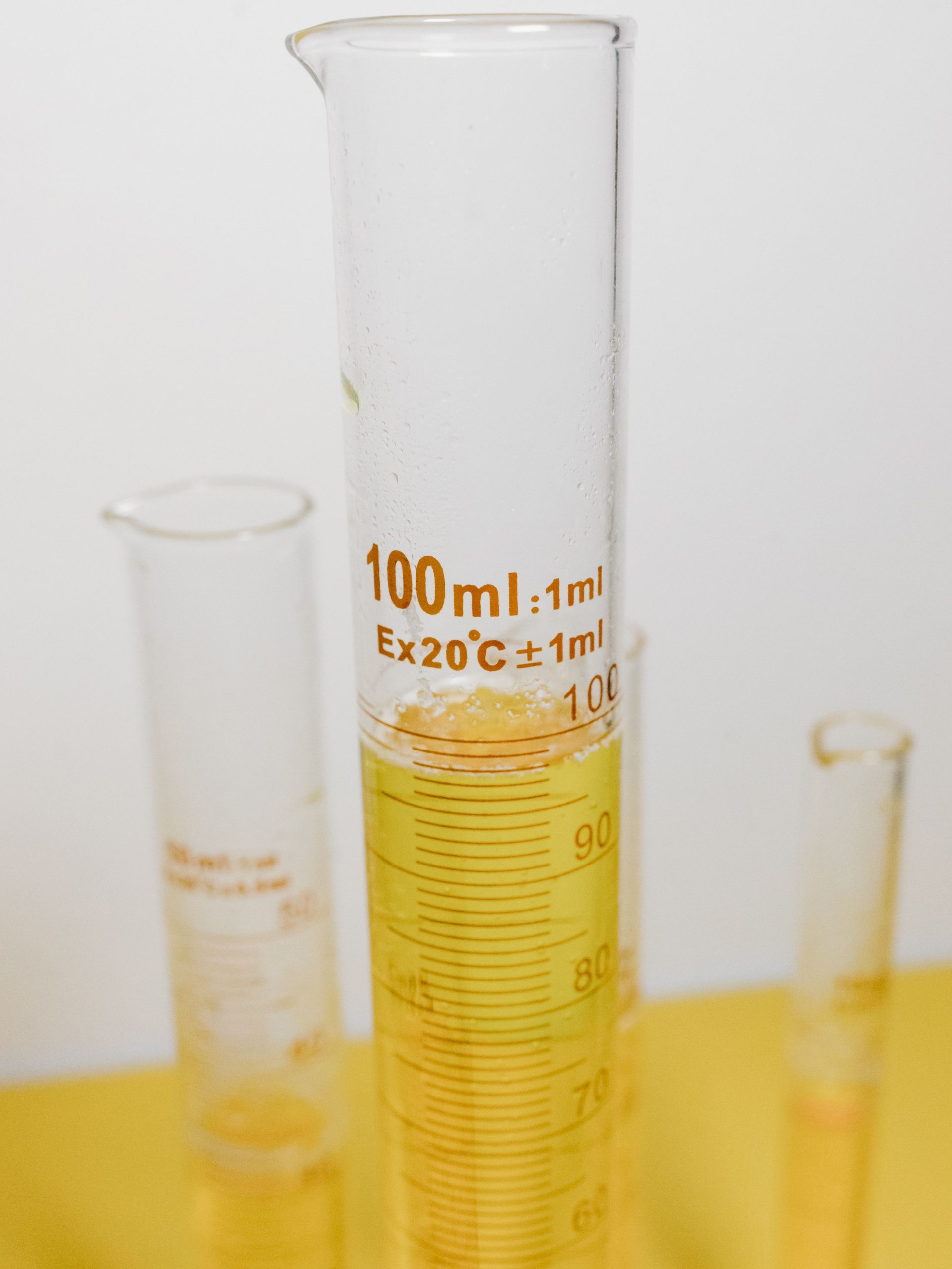 Copper Corrosion Inhibitor light‑amber clear metal‑working fluid additive sample in graduated cylinder