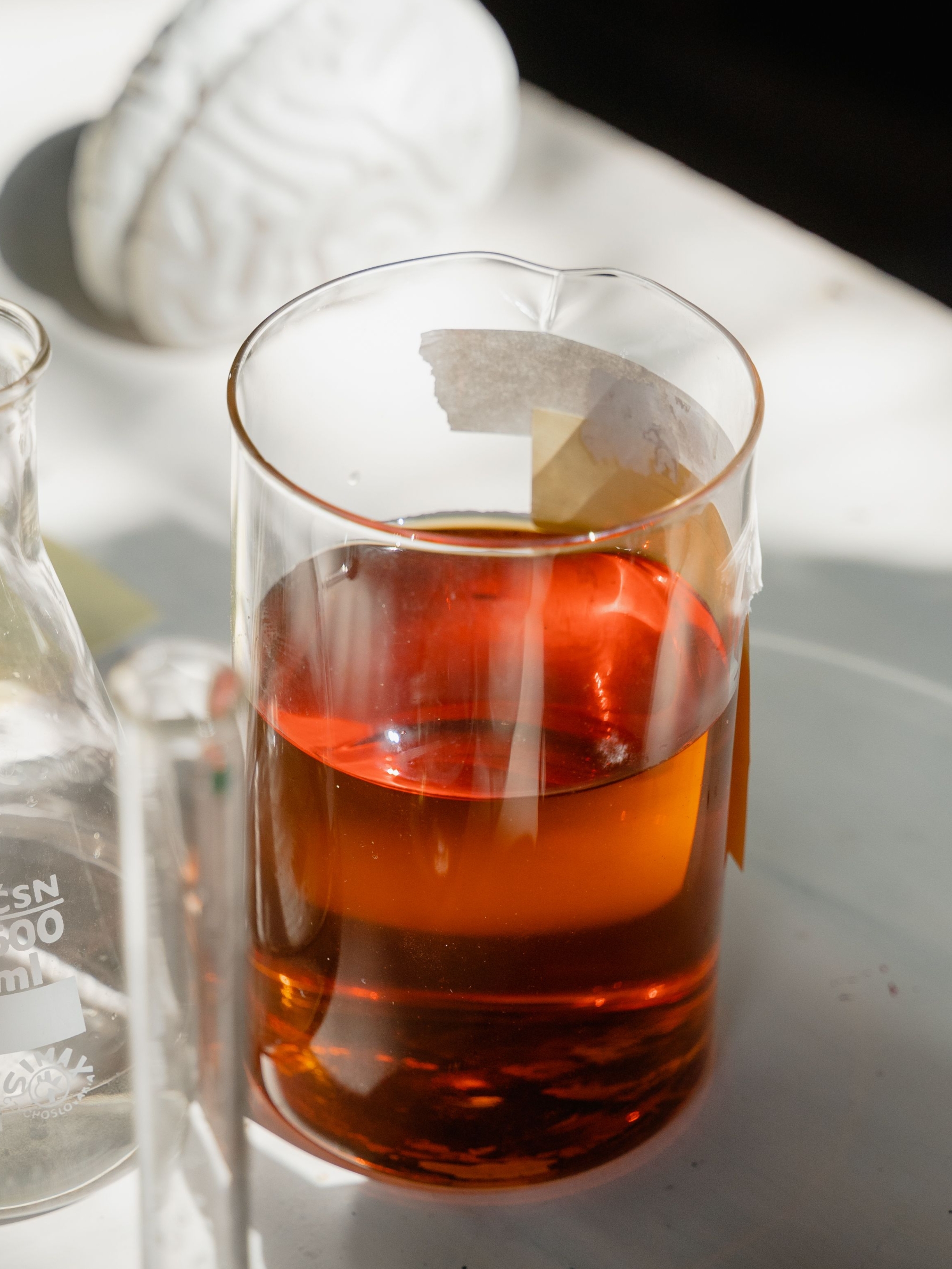 Copper Corrosion Inhibitor light‑amber clear metal‑working fluid additive sample in graduated cylinder